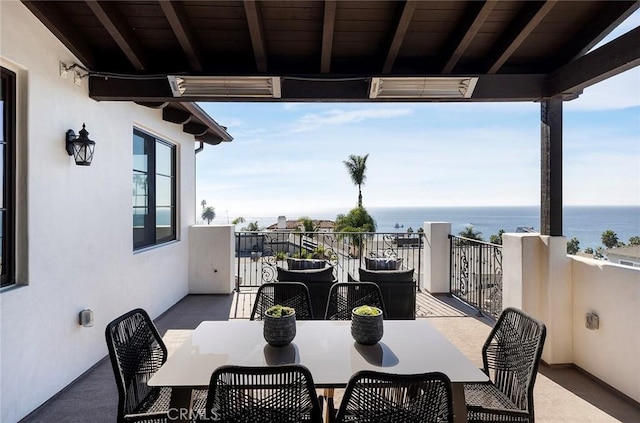 view of patio / terrace with a water view and a balcony