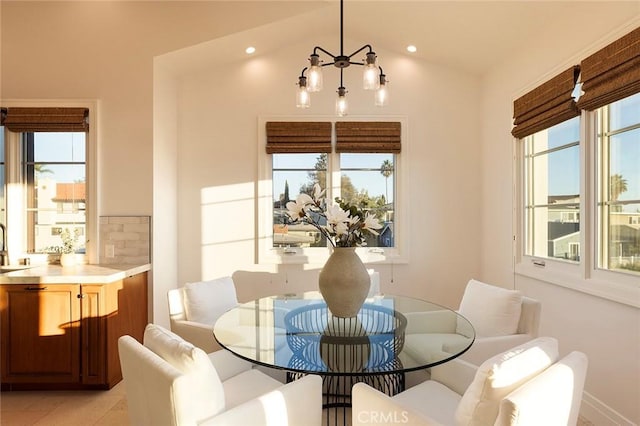 dining room featuring lofted ceiling and a healthy amount of sunlight