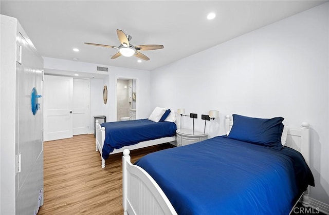 bedroom with ceiling fan, a closet, and light hardwood / wood-style floors