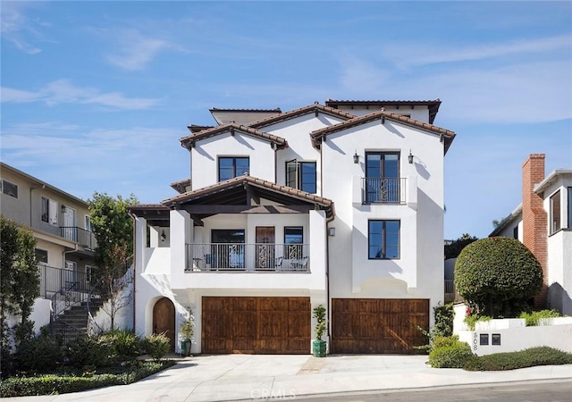 mediterranean / spanish house featuring a balcony and a garage