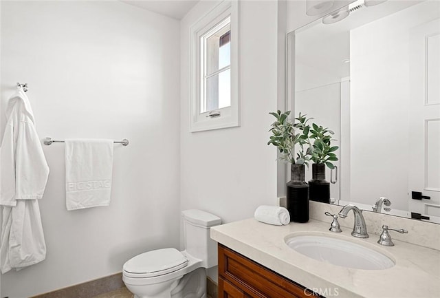 bathroom featuring toilet and vanity