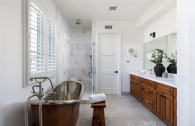 bathroom with a shower with shower door and vanity