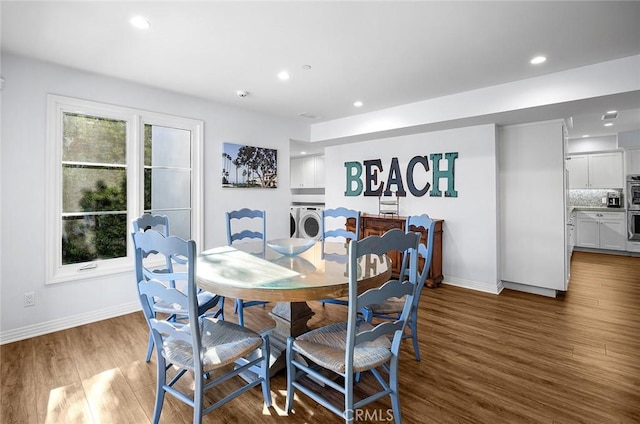 dining area with washer and clothes dryer and dark hardwood / wood-style flooring