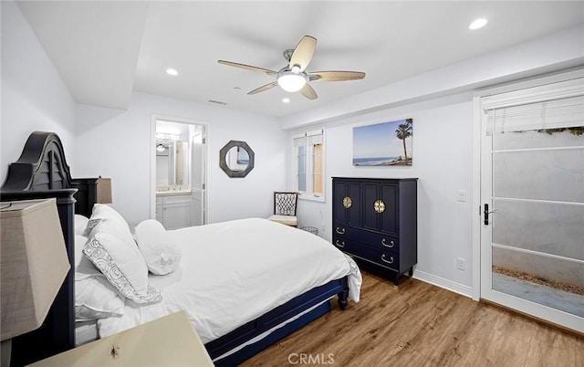 bedroom featuring ceiling fan, hardwood / wood-style floors, and ensuite bathroom