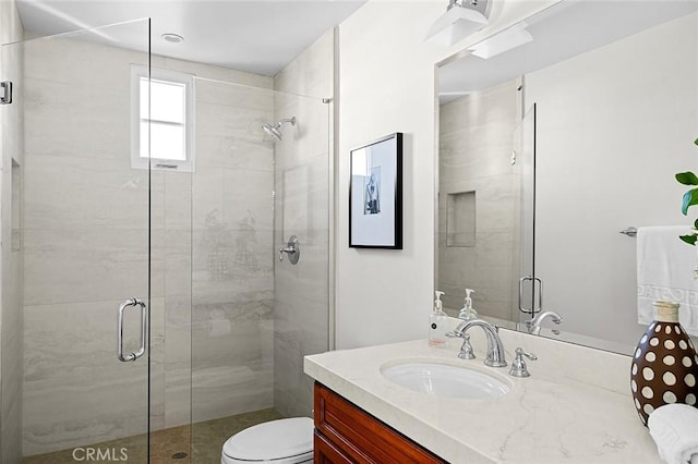 bathroom with a shower with door, toilet, and vanity