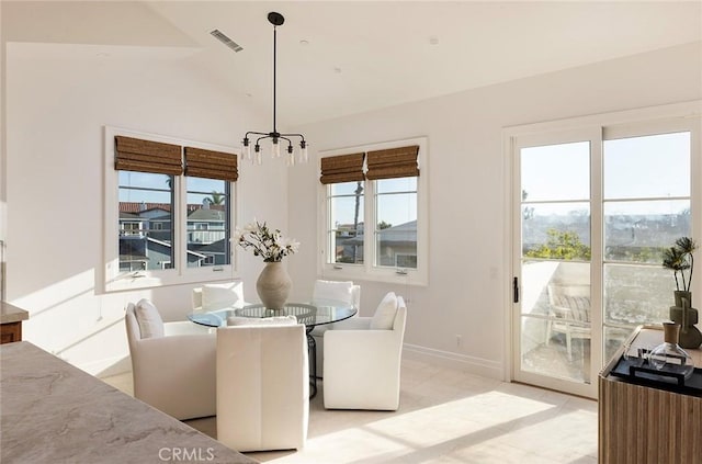 dining room featuring lofted ceiling and plenty of natural light