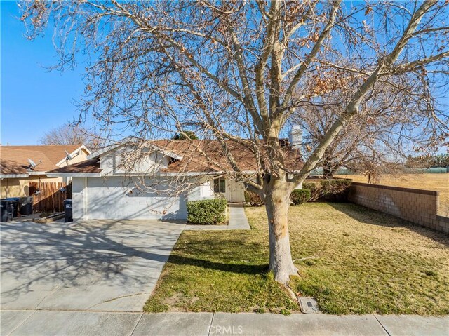 view of front of property with a front yard and a garage