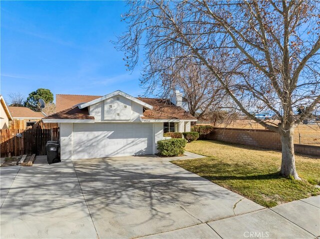 view of front of home with a front yard and a garage