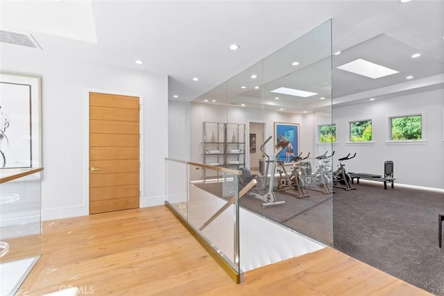 exercise room featuring light wood-type flooring