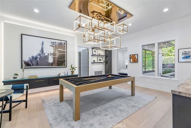 game room with billiards and light hardwood / wood-style flooring