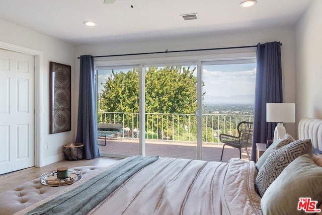 bedroom featuring access to outside and hardwood / wood-style flooring