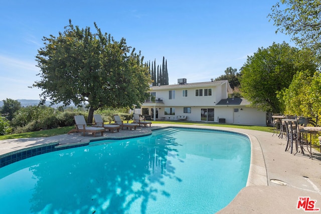 view of pool with central AC and a patio area