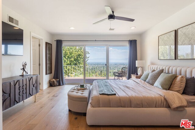 bedroom with light wood-type flooring, ceiling fan, access to outside, and multiple windows