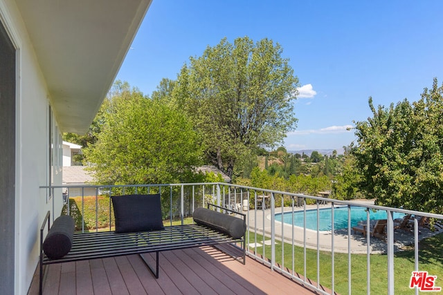 wooden deck featuring a fenced in pool