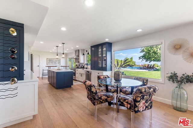 dining space with sink and light wood-type flooring