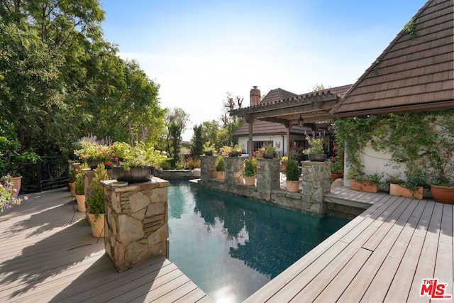 view of pool with a wooden deck