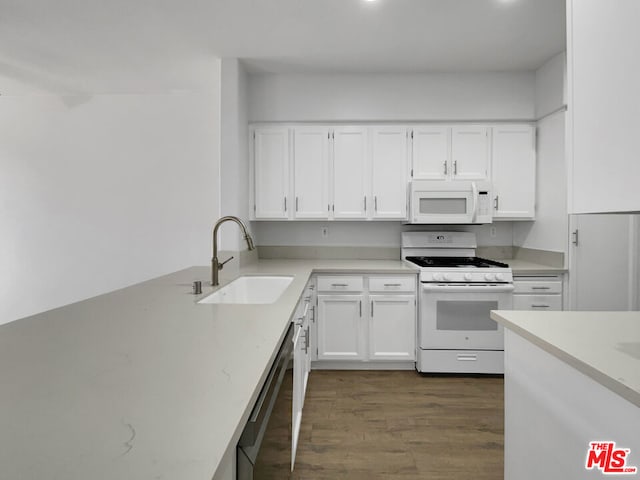 kitchen with white cabinetry, sink, white appliances, and dark wood-type flooring