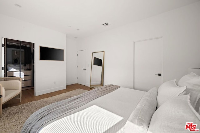 bedroom featuring hardwood / wood-style flooring