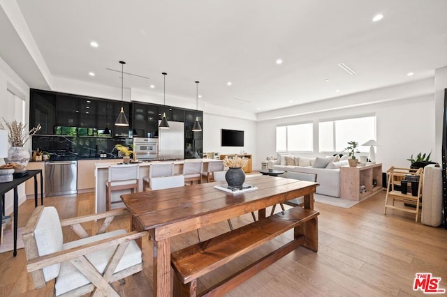 dining space featuring light wood-type flooring