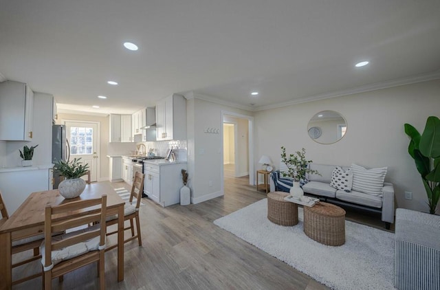 living room featuring light hardwood / wood-style floors and ornamental molding