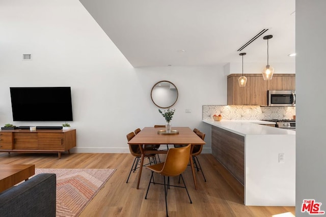 dining space with light hardwood / wood-style floors