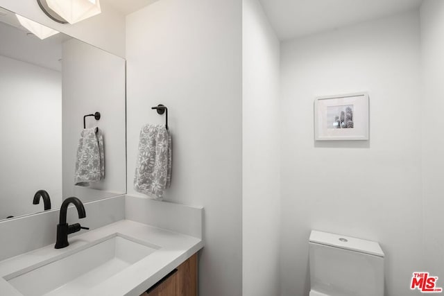 bathroom featuring toilet and vanity