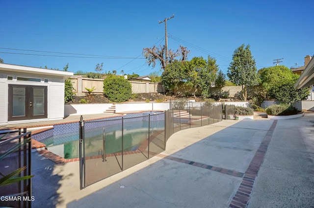 view of pool with a patio area and french doors