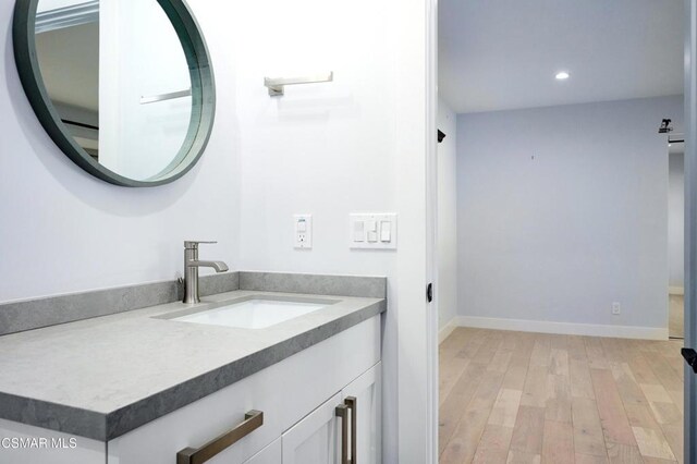 bathroom featuring hardwood / wood-style floors and vanity