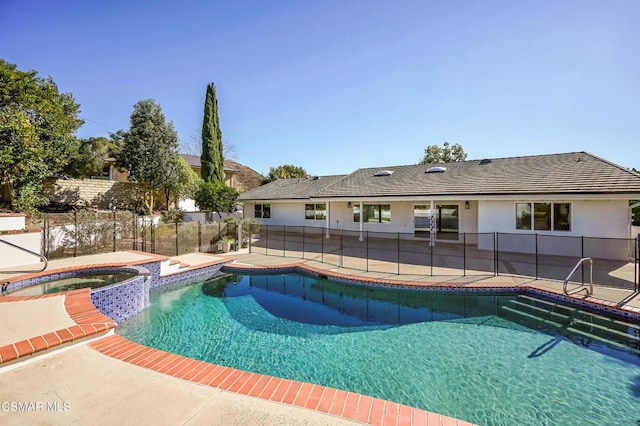 view of swimming pool with a patio area and an in ground hot tub