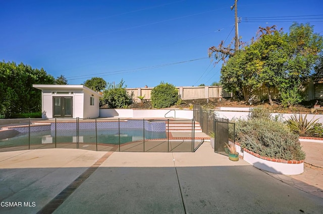 view of swimming pool with a patio and an outdoor structure