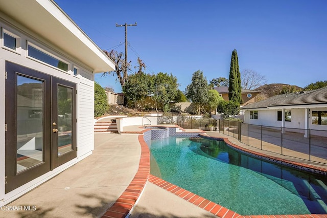 view of swimming pool with an in ground hot tub and a patio area