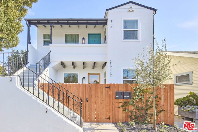 view of front of home featuring a balcony