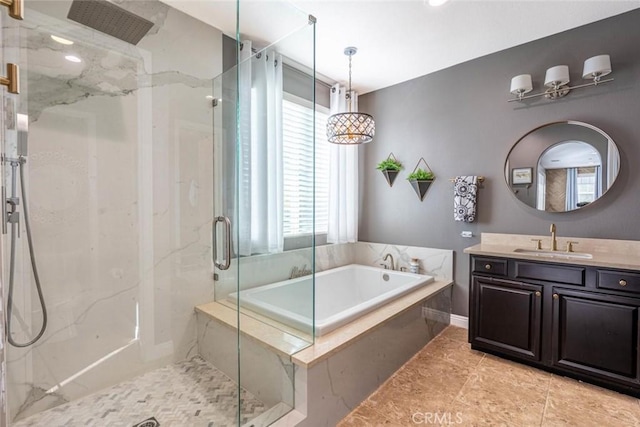 bathroom with vanity and separate shower and tub