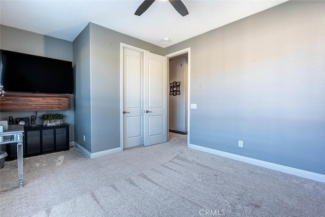 unfurnished bedroom featuring ceiling fan and carpet