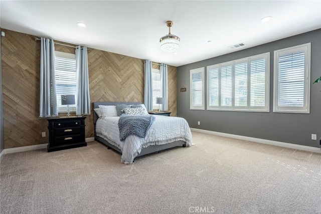 bedroom with carpet and wooden walls