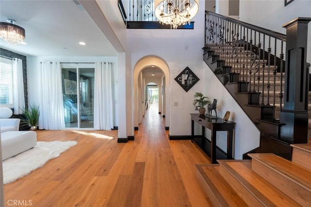 foyer with wood-type flooring and an inviting chandelier