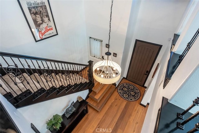 entrance foyer with wood-type flooring and a notable chandelier