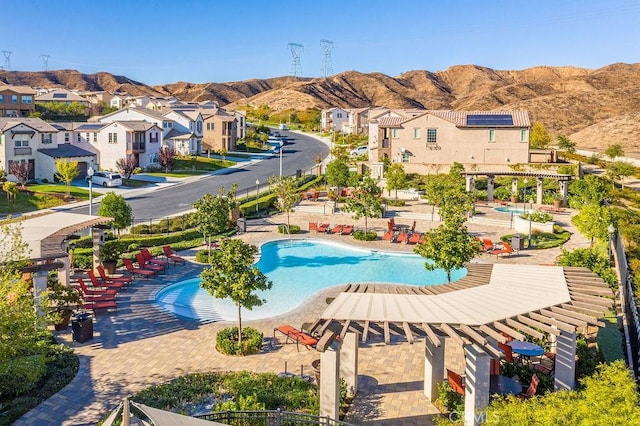 view of swimming pool featuring a mountain view, a gazebo, and a patio