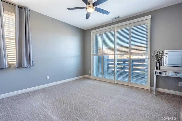 carpeted spare room with ceiling fan