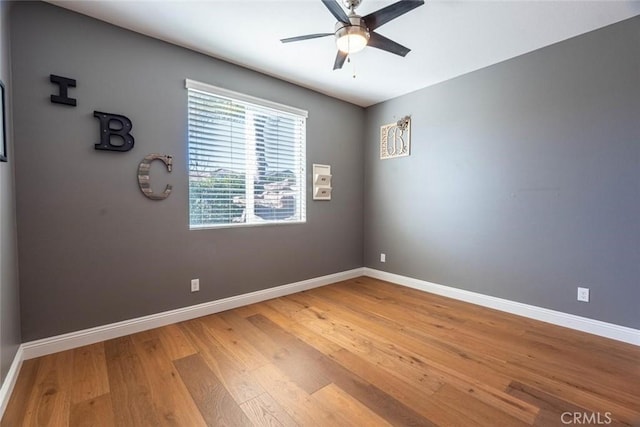 unfurnished room with ceiling fan and wood-type flooring