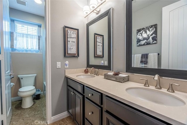 bathroom featuring toilet and vanity