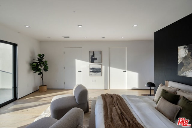 bedroom with light hardwood / wood-style floors