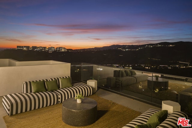 patio terrace at dusk featuring an outdoor living space