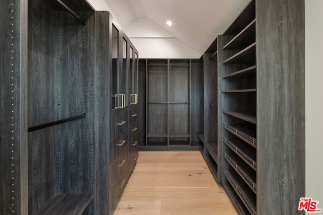 spacious closet featuring lofted ceiling and light wood-type flooring