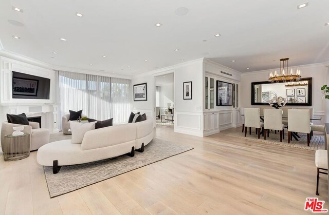 living room with wine cooler, crown molding, and light hardwood / wood-style flooring