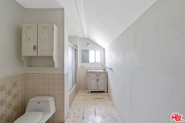 full bathroom featuring lofted ceiling, vanity, tile walls, and toilet