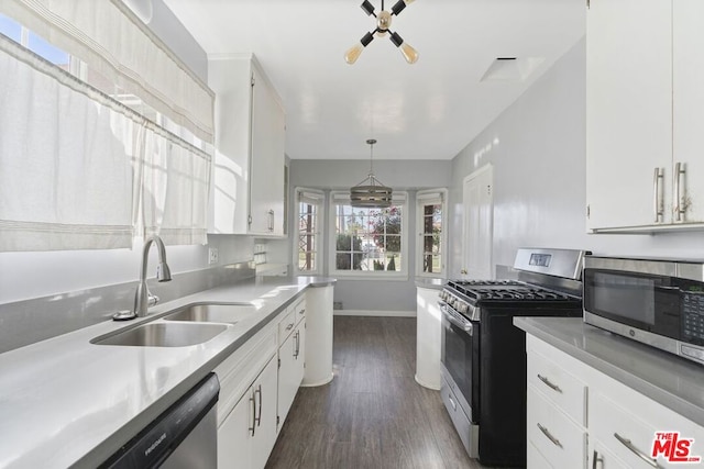 kitchen featuring stainless steel appliances and white cabinetry