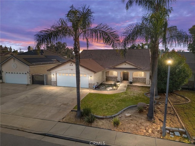 view of front of home featuring a garage and a lawn