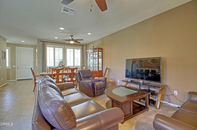 tiled living room with ceiling fan