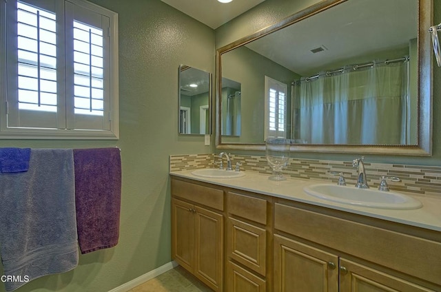 bathroom featuring a shower with shower curtain, backsplash, and vanity